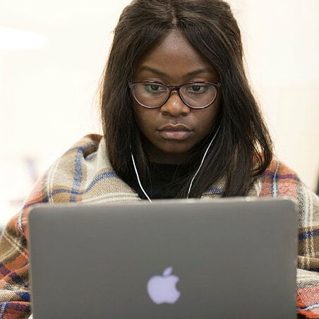 A woman working on a laptop.