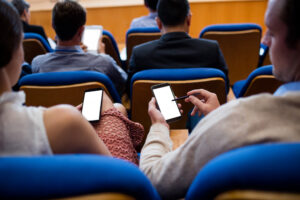 People using phones in a lecture.